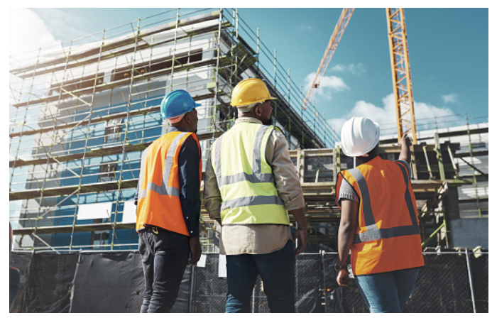 Construction professionals reviewing a building project on site