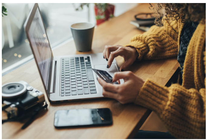 Customer making an online purchase using a laptop and payment card